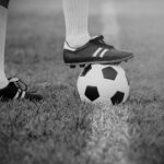 soccer or football player standing with ball on the field for Kick the soccer ball